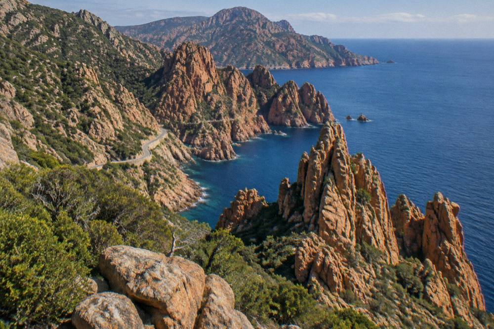 Red granite rock formations of the Calanques de Piana above the sea