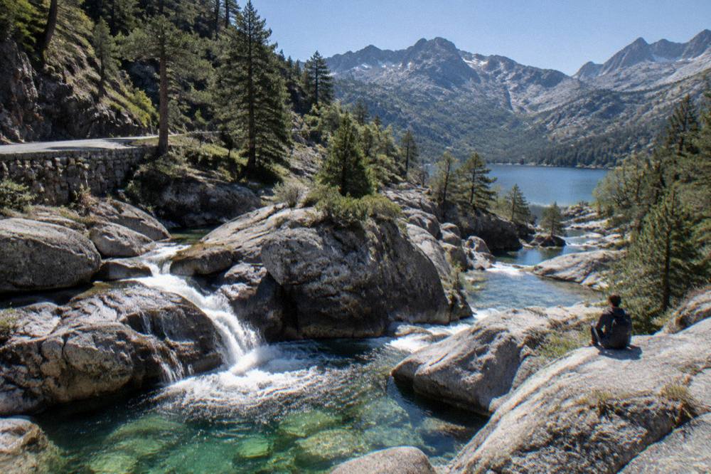 A mountain lake ringed by granite peaks in the Restonica valley near Corte