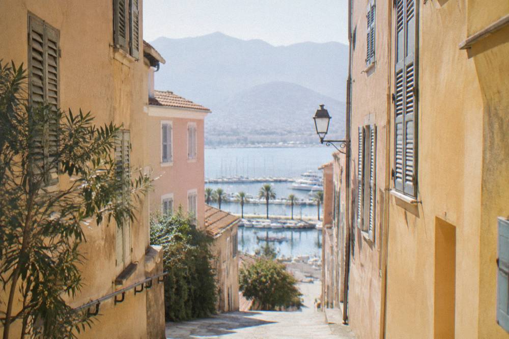 A quiet morning street in the old town of Ajaccio with pastel facades and shutters