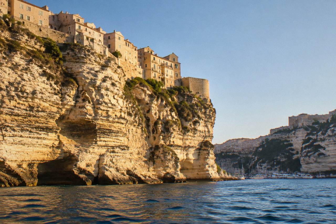 The limestone cliffs and harbour of Bonifacio seen from the sea on a clear day