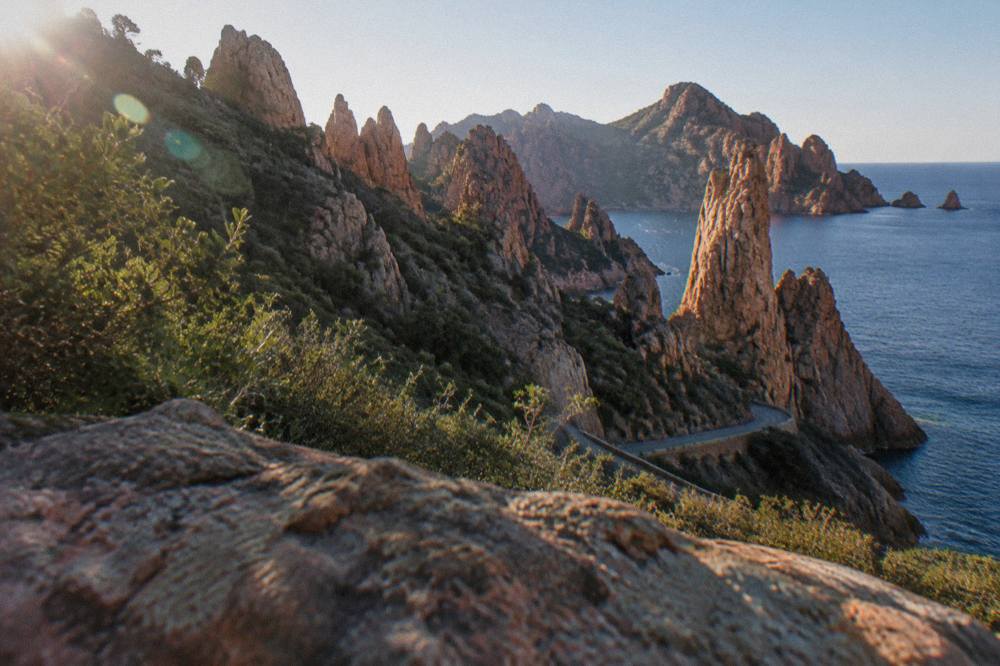 Red granite rock formations of the Calanques de Piana above the sea on a clear day