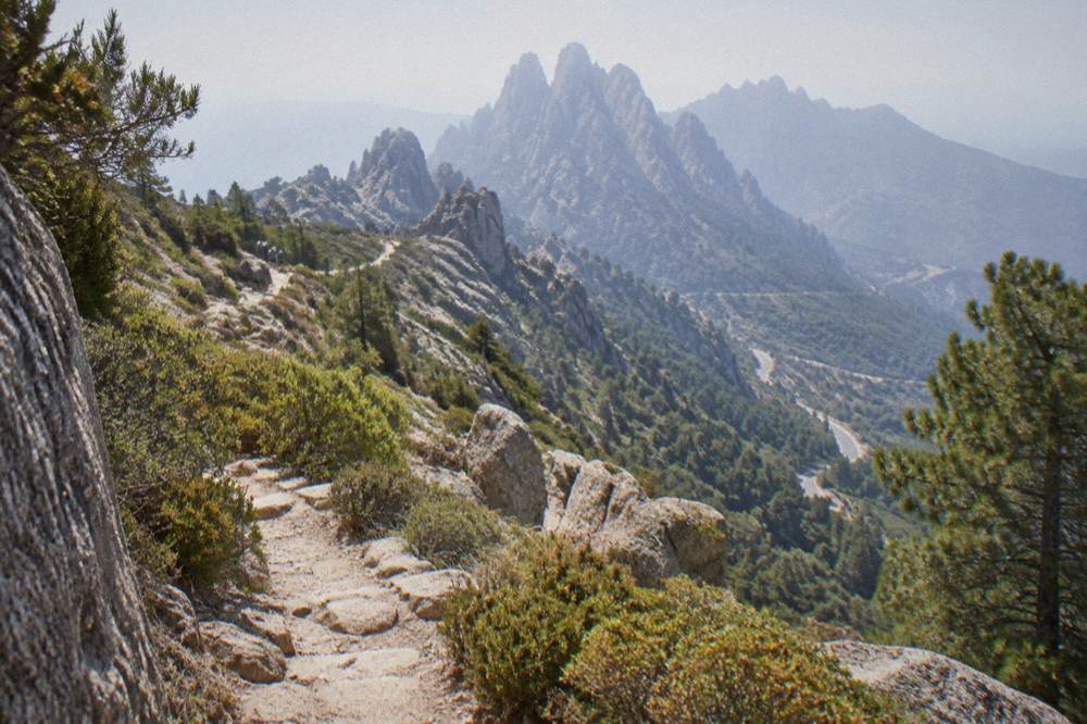 A mountain footpath climbing through granite scenery toward a ridge line