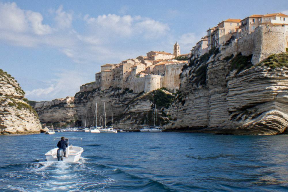 The old town of Bonifacio seen from the water with cliffs and rooftops