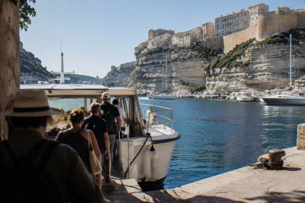 Passengers boarding a tour boat at the quay in Bonifacio harbour
