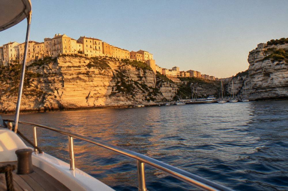 Sunset light on the cliffs and harbour of Bonifacio from the deck of a boat