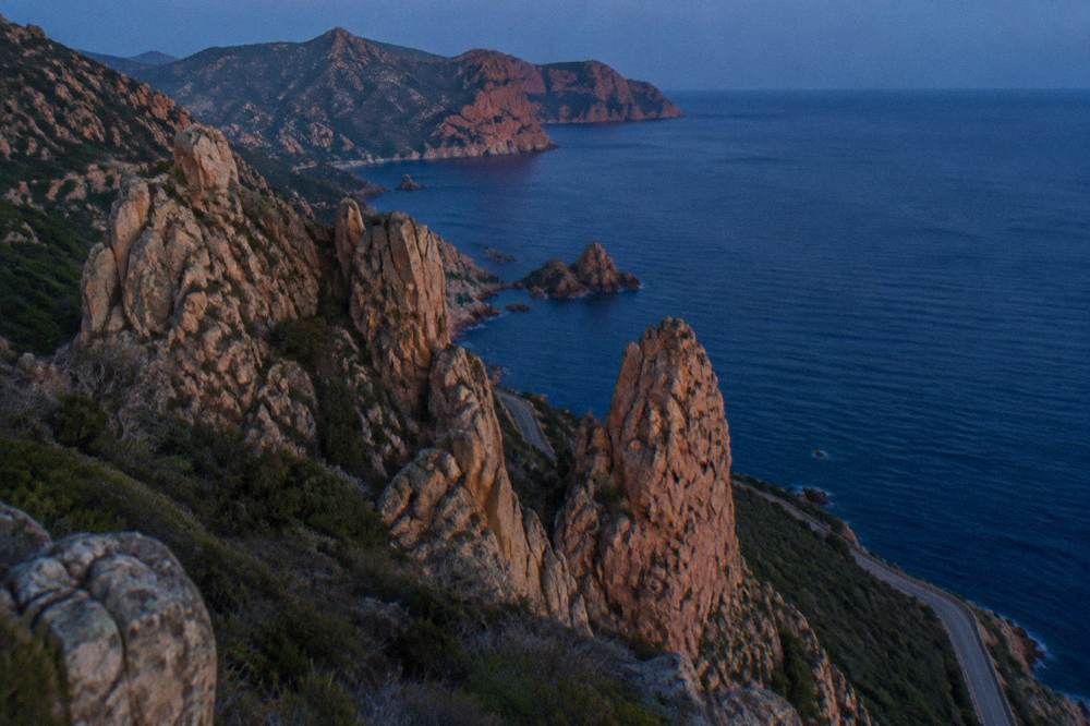 Granite rock formation above the water in the Calanques de Piana under a clear sky